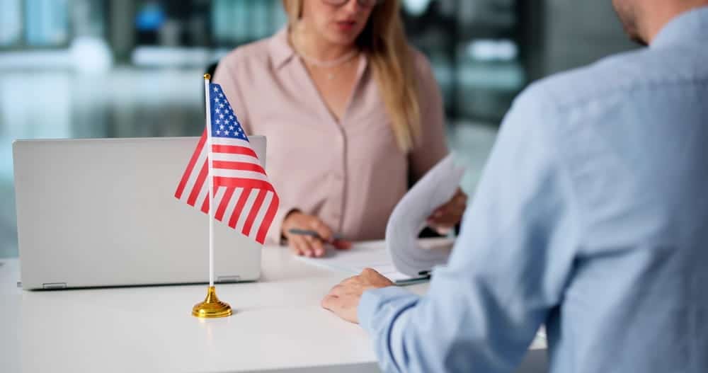 Immigration attorney meeting with a client to discuss adjustment of status after a visa overstay